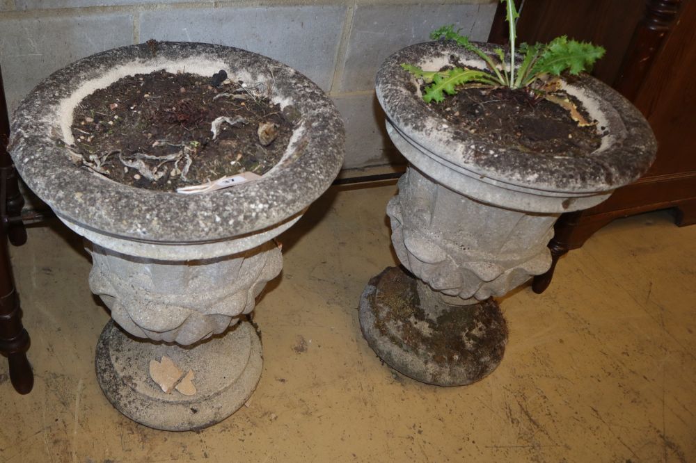 A pair of reconstituted stone campana garden urns, 40cm diameter, H.50cm